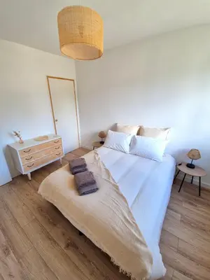 a bedroom with a large white bed with towels on it at Appartement Ajaccio vue mer in Ajaccio