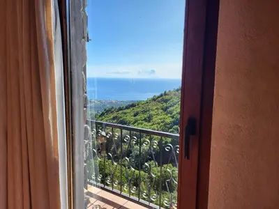 a view of the ocean from a window at House between the sea and the mountain in San-Giovanni-di-Moriani