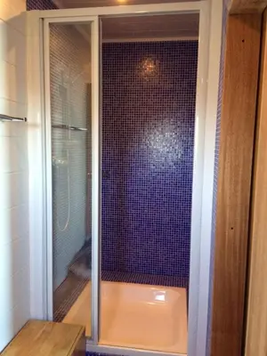 a shower with a glass door in a bathroom at House between the sea and the mountain in San-Giovanni-di-Moriani