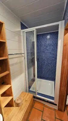 a small bathroom with a shower and a tub at House between the sea and the mountain in San-Giovanni-di-Moriani