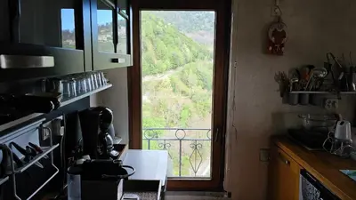 a kitchen with a window with a view of a mountain at House between the sea and the mountain in San-Giovanni-di-Moriani