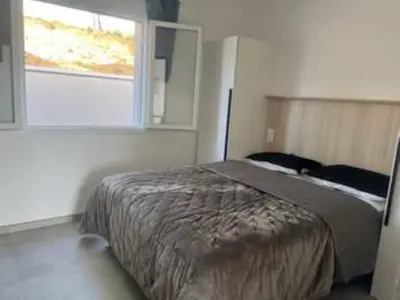 a bedroom with a bed and a window at E casette in Oletta