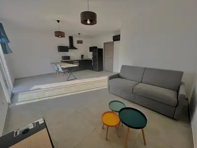 a living room with a couch and two colorful tables at E casette in Oletta