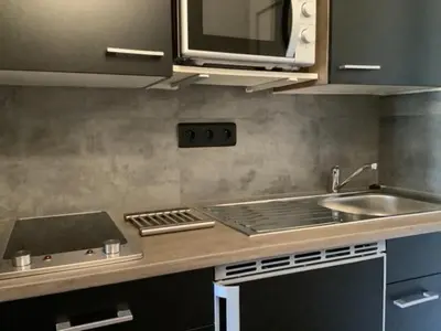 a kitchen with a sink and a microwave at Secret creek in Zonza