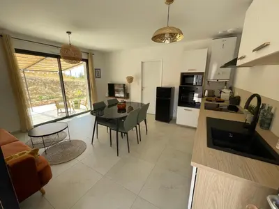 a kitchen and living room with a table and chairs at Magnifique appartement T2 in Cuttoli-Corticchiato