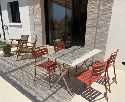 a table and four chairs on a patio at Magnifique appartement T2 in Cuttoli-Corticchiato