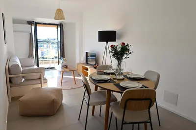 a living room with a dining room table and chairs at La Pépite Corse - Magnifique T2 cabine vue mer in Pianottoli-Caldarello