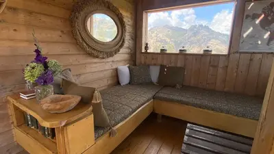 a room with a bench in a cabin with a window at Cocoon Village in Porto-Vecchio