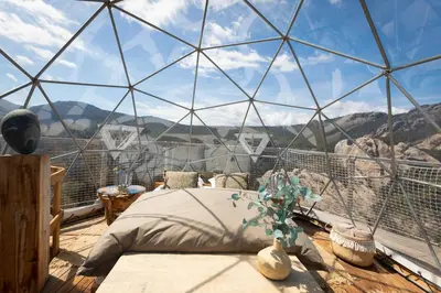 a glass dome bedroom with a bed and a view at Cocoon Village in Porto-Vecchio