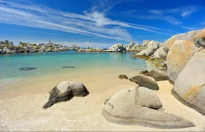 a beach with some rocks and water and acean at Appartement design in Porto-Vecchio