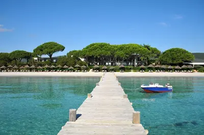 a boat sitting on the water next to a dock at Appartement design in Porto-Vecchio