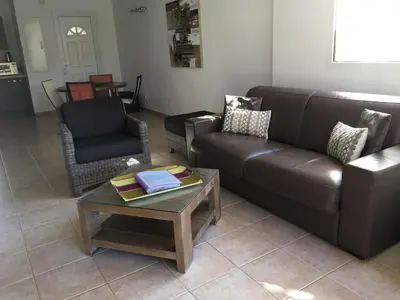 a living room with a couch and a coffee table at Appartement design in Porto-Vecchio