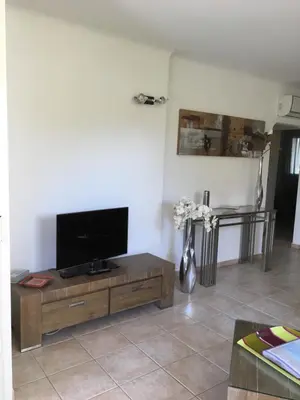 a living room with a flat screen tv on a table at Appartement design in Porto-Vecchio
