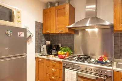 a kitchen with a stove and a refrigerator at Casa Pruno in Pruno