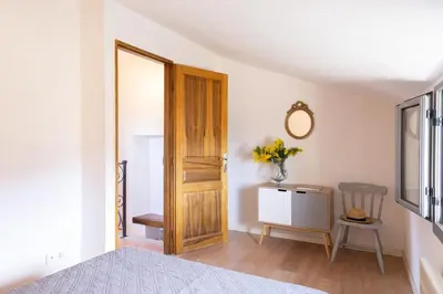 a bedroom with a door and a table and a chair at Casa Pruno in Pruno