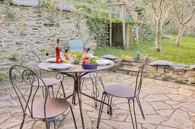 a table and chairs sitting on a patio at Casa Pruno in Pruno