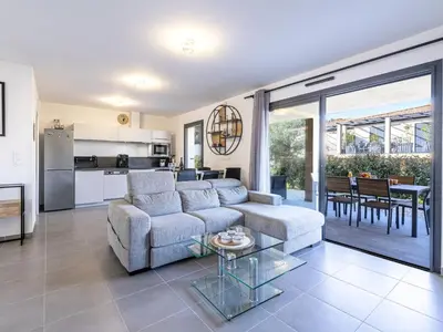 a living room with a couch and a table at Apartment Foce Dell Edera-2 by Interhome in Bonifacio