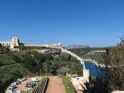 a group of cars parked on the side of a hill with a bridge at Apartment Foce Dell Edera-2 by Interhome in Bonifacio