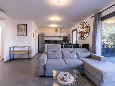 a living room with two couches and a kitchen at Apartment Foce Dell Edera-2 by Interhome in Bonifacio