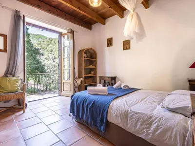 a bedroom with a bed and an open door at Holiday Home Casa Gialla by Interhome in Arraggio