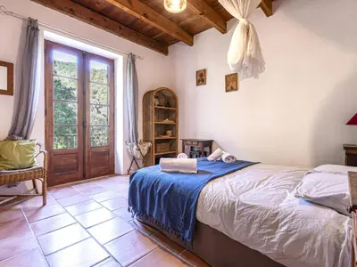 a bedroom with a bed with blue sheets and a window at Holiday Home Casa Gialla by Interhome in Arraggio