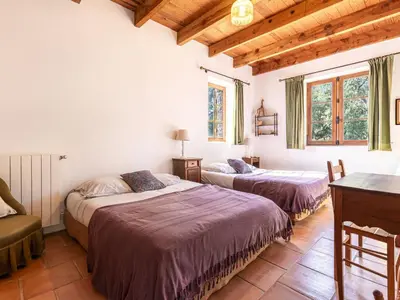 two beds in a room with wooden ceilings at Holiday Home Casa Gialla by Interhome in Arraggio