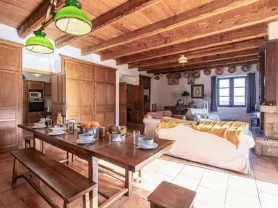 a kitchen and living room with a wooden table at Holiday Home Casa Gialla by Interhome in Arraggio