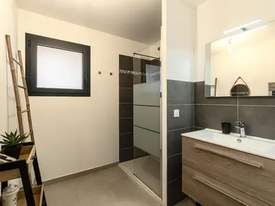 a bathroom with a sink and a mirror at Apartment Foce Dell Edera-1 by Interhome in Bonifacio