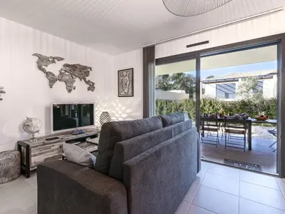 a living room with a couch and a television at Apartment Foce Dell Edera-1 by Interhome in Bonifacio