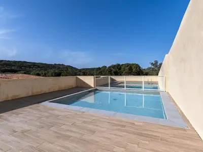 a swimming pool on the side of a house at Apartment Foce Dell Edera-1 by Interhome in Bonifacio