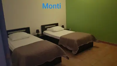 two beds in a room with a sign on the wall at Gite de 90m2 proche de la mer avec grande piscine MONTI in Canale-di-Verde