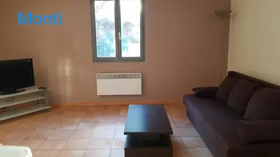 a living room with a couch and a table at Gite de 90m2 proche de la mer avec grande piscine MONTI in Canale-di-Verde