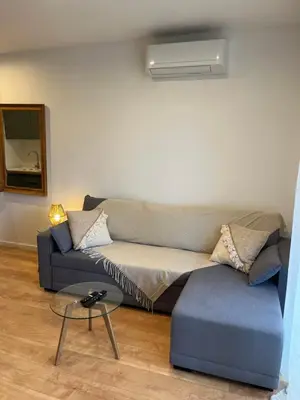 a living room with a couch and a table at Charmant Studio à Ajaccio in Ajaccio