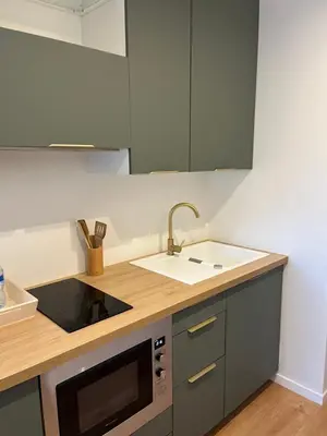 a kitchen with a sink and a microwave at Charmant Studio à Ajaccio in Ajaccio