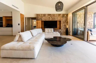 a living room with a white couch and a table at luxury villa les Kiks 5 chambres, piscine chauffée, Lecci in Lecci