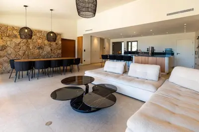 a living room with a couch and a table at luxury villa les Kiks 5 chambres, piscine chauffée, Lecci in Lecci