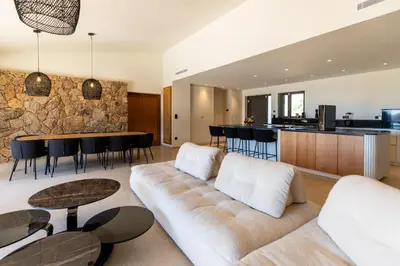 a living room with a couch and a table at luxury villa les Kiks 5 chambres, piscine chauffée, Lecci in Lecci