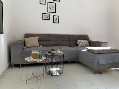 a living room with a couch and a table at Appartement en centre ville in Corte