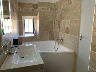 a bathroom with a sink and a toilet and a shower at Appartement en centre ville in Corte