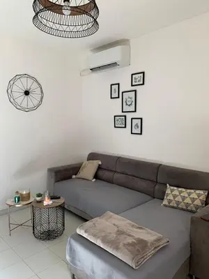 a living room with a couch and a table at Appartement en centre ville in Corte