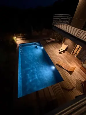 an overhead view of a swimming pool at night at Villa Ondella - Villa entre plages et sentiers in Pianottoli-Caldarello