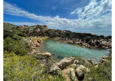 a body of water with rocks and a river at Villa Ondella - Villa entre plages et sentiers in Pianottoli-Caldarello