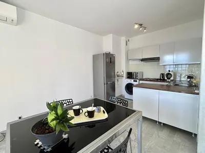 a kitchen with a table with a potted plant on it at Studio vue mer le Neptune sanguinaires Ajaccio in Ajaccio