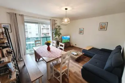 a living room with a blue couch and a table at Charming T3 with balconies in Ajaccio in Ajaccio