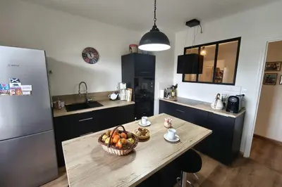 a kitchen with a table with a bowl of fruit on it at Charming T3 with balconies in Ajaccio in Ajaccio