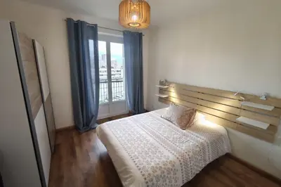 a small bedroom with a bed and a window at Charming T3 with balconies in Ajaccio in Ajaccio
