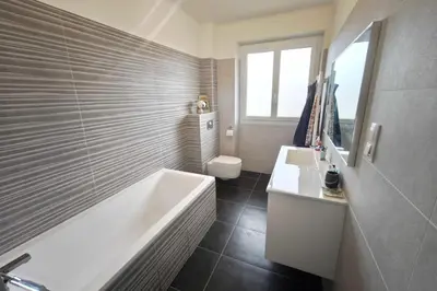 a bathroom with a tub and a sink and a toilet at Charming T3 with balconies in Ajaccio in Ajaccio