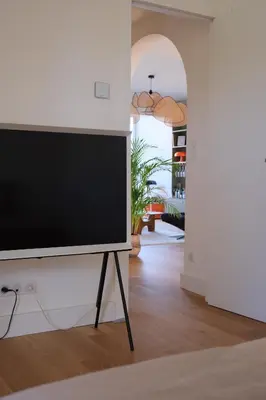 a flat screen tv on a stand in a living room at Magnifique T3 de 85m2 de standing vue mer trottel in Ajaccio