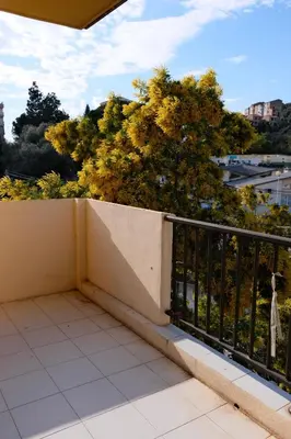 a balcony with a fence and trees in the background at Magnifique T3 de 85m2 de standing vue mer trottel in Ajaccio