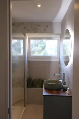 a bathroom with a sink and a shower at Magnifique T3 de 85m2 de standing vue mer trottel in Ajaccio